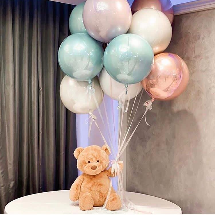 multicolor balloons bouquet with teddy holding it