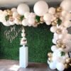 gold and white themed balloon backdrop for party