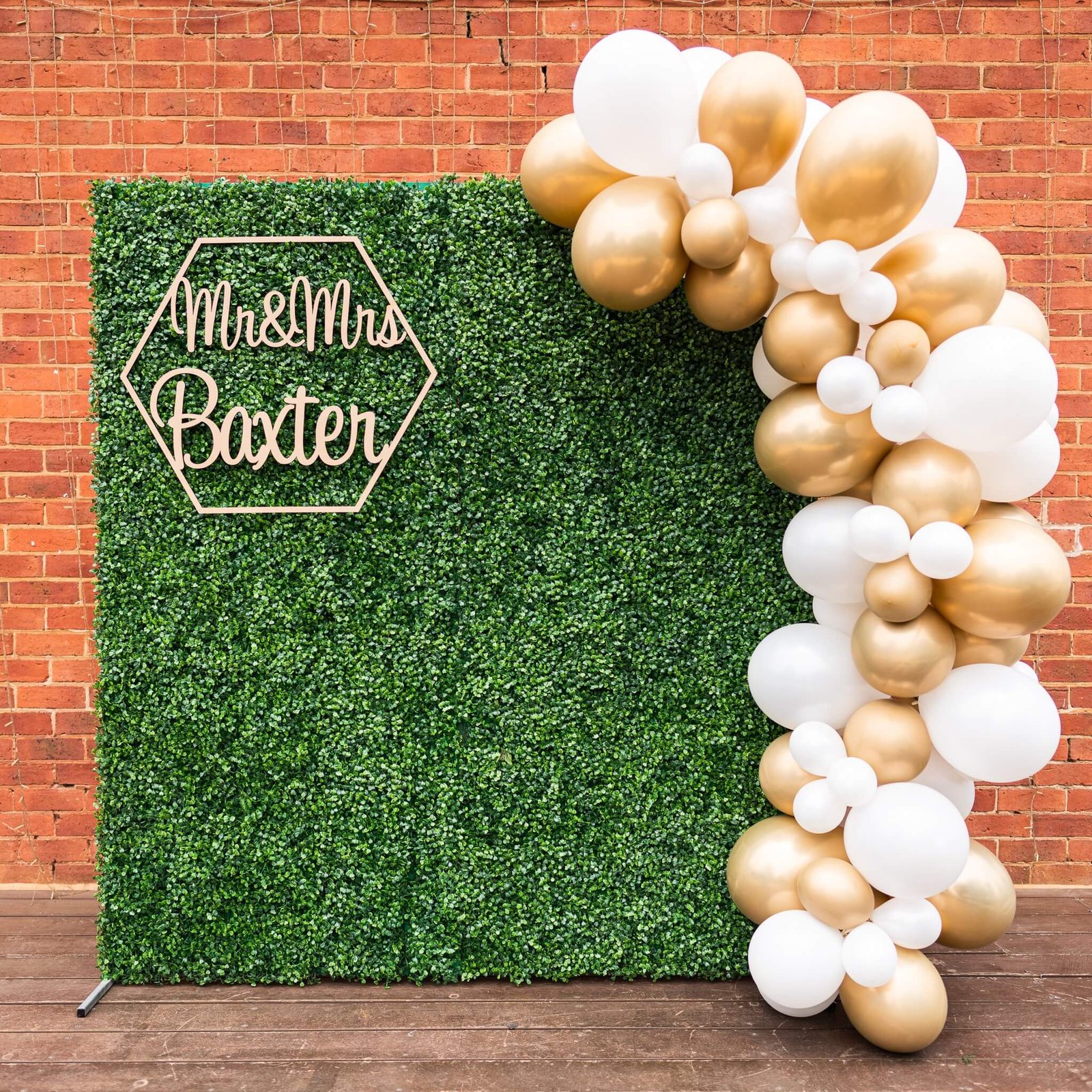 white and gold arch shaped balloon backdrop for party
