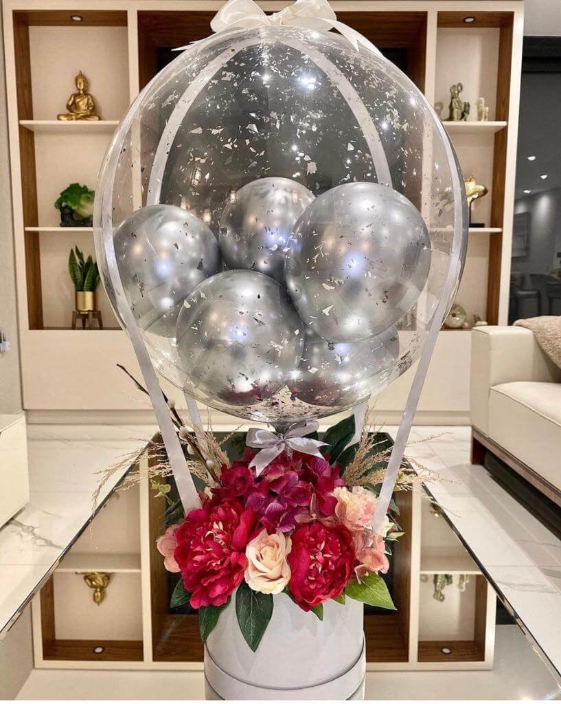 silver colored hot air balloons and flower gift hamper
